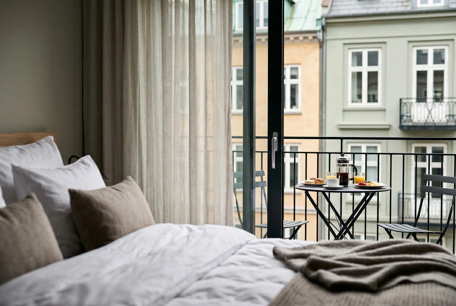 A Scandinavian hotel room with a balcony breakfast