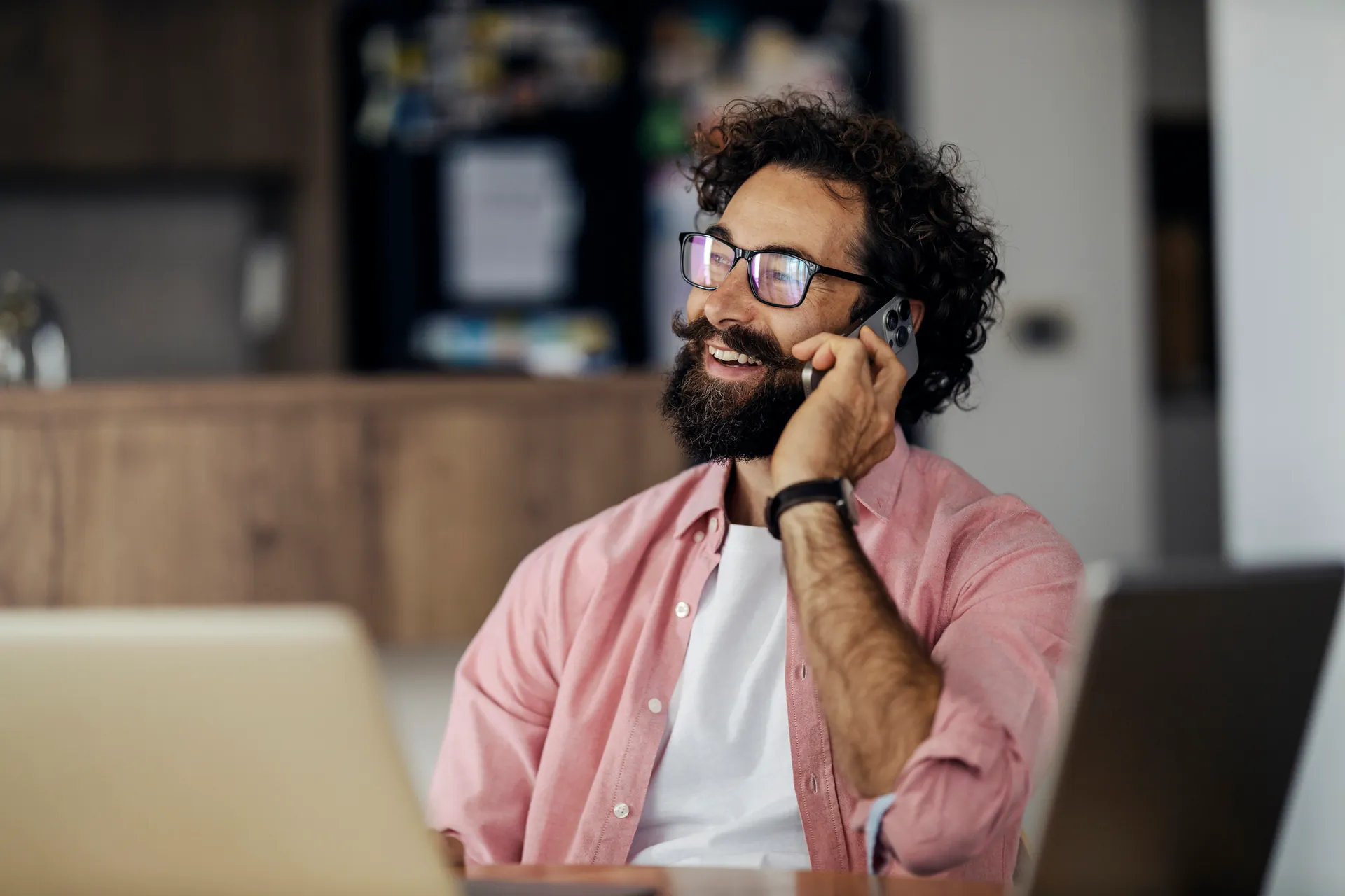 A host on a video call while working on a laptop
