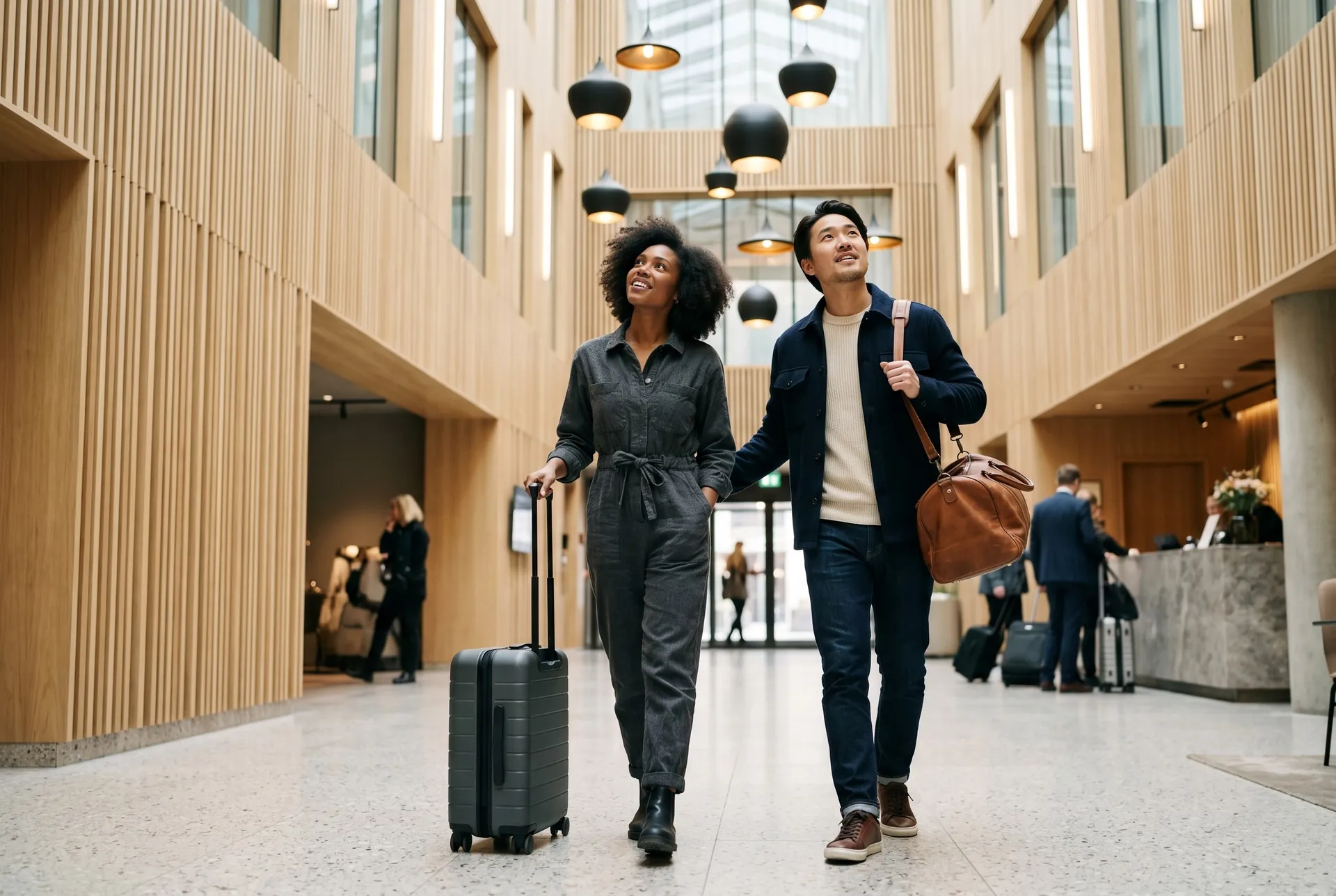 A couple with luggage arriving in a hotel lobby