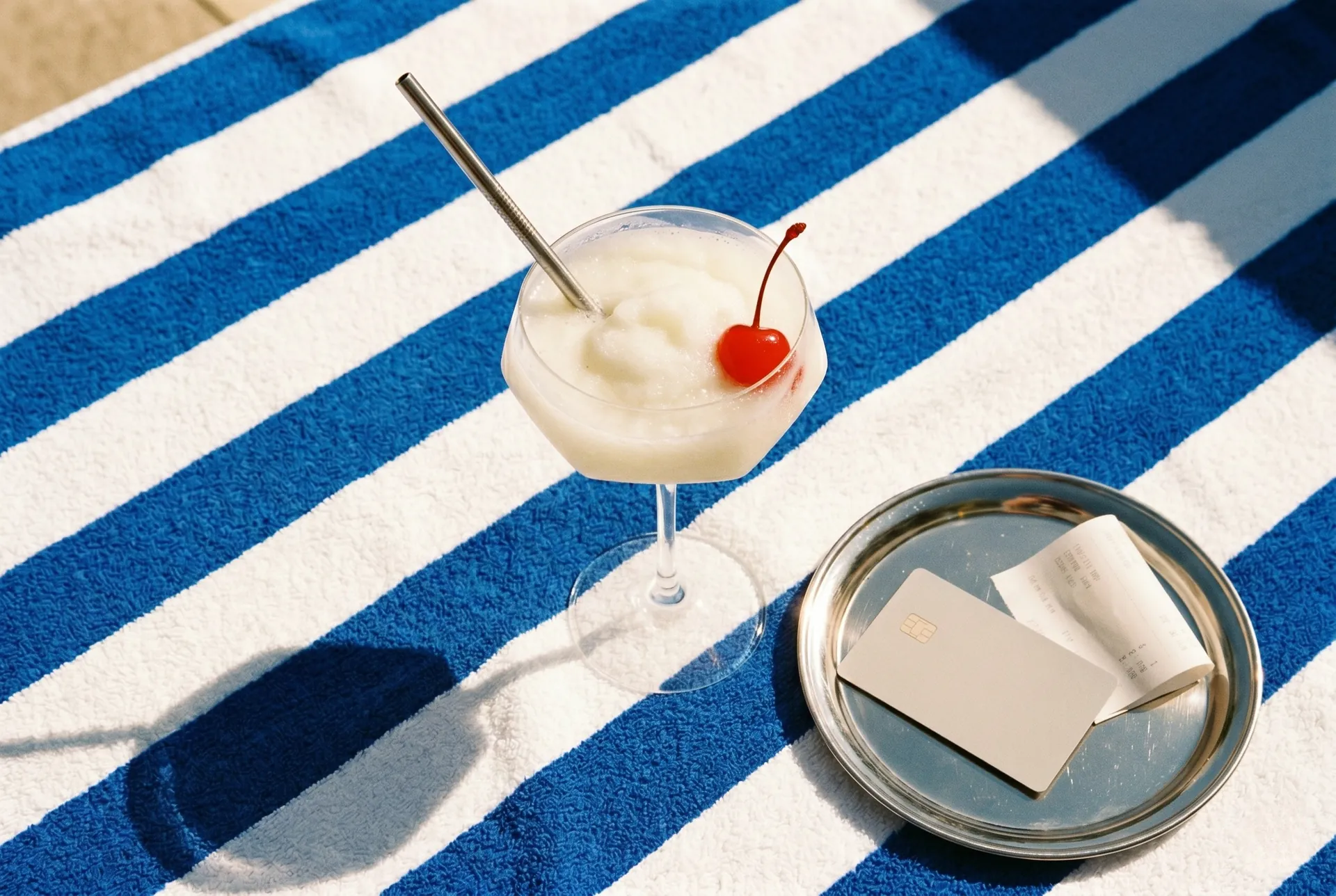 A card payment on a terminal beside a cocktail